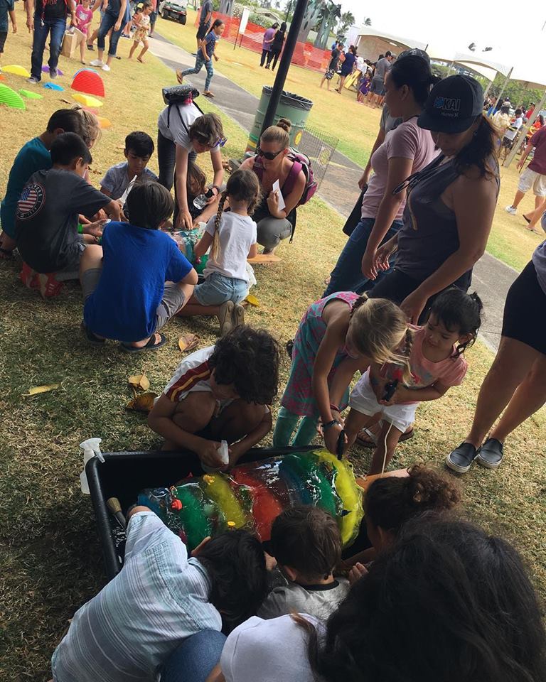 At Keiki Fest 2019, parents watch their young children play games.