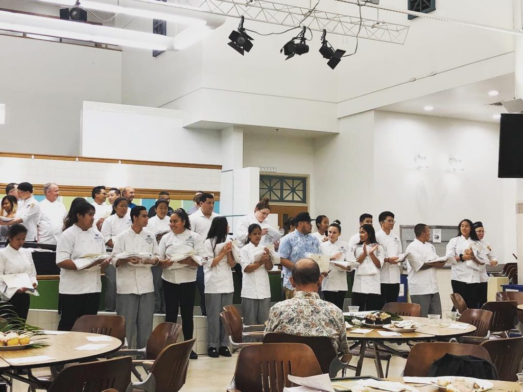 Culinary students receive their white jackets.