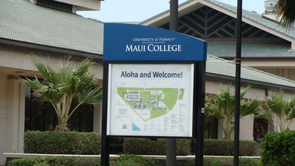 Building of UHMC with a sign displaying a map of the campus.