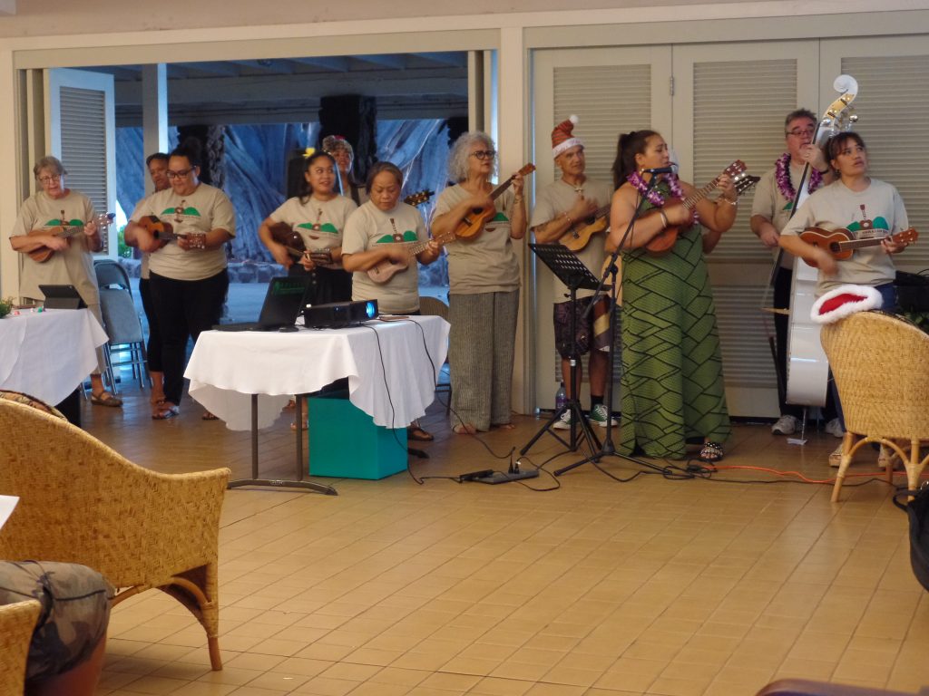 Students play Hawaiian music at the Christmas gathering. 