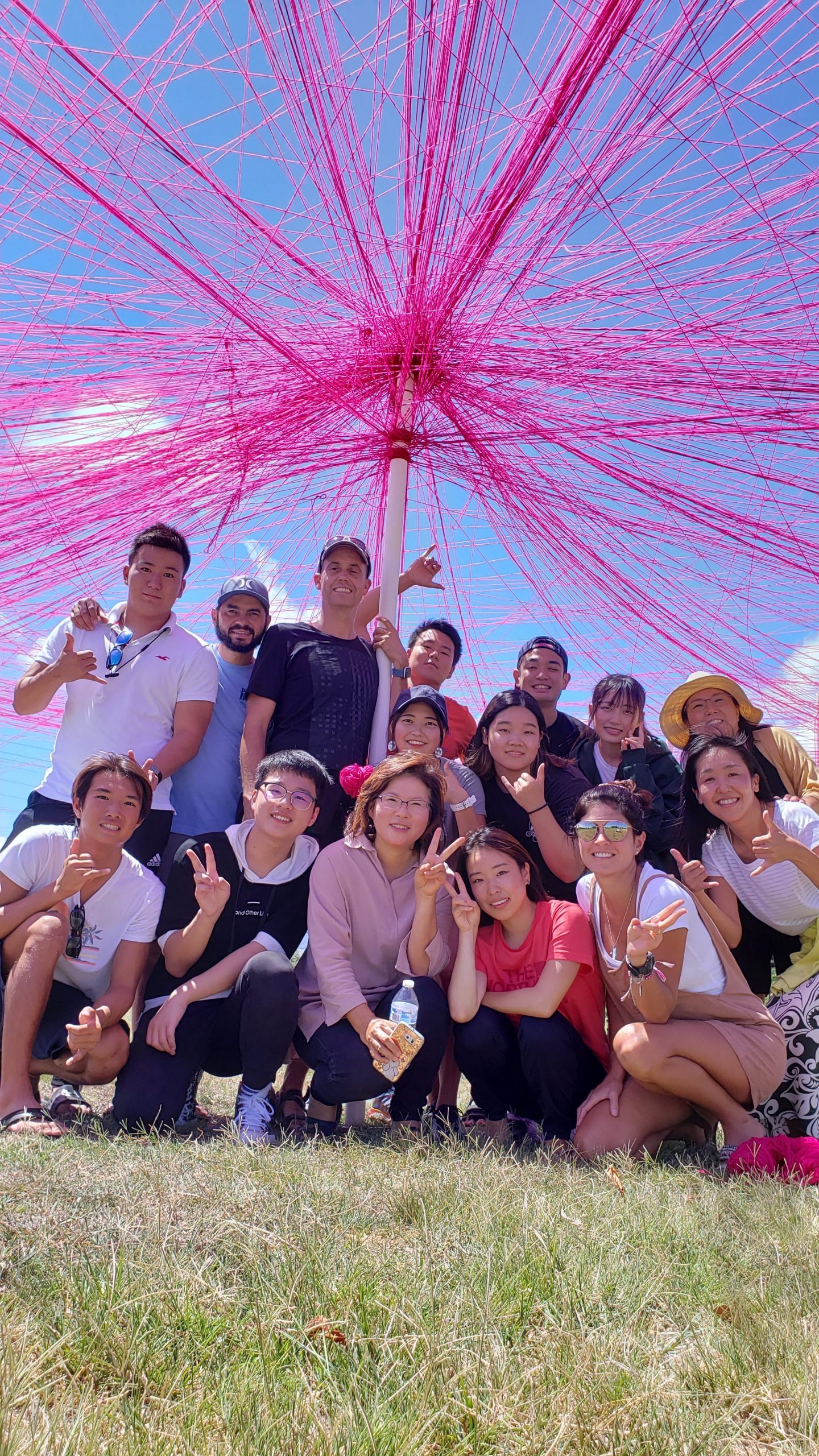 Maui Language Institute students pose in front of the unity project at UH Maui College Great Lawn