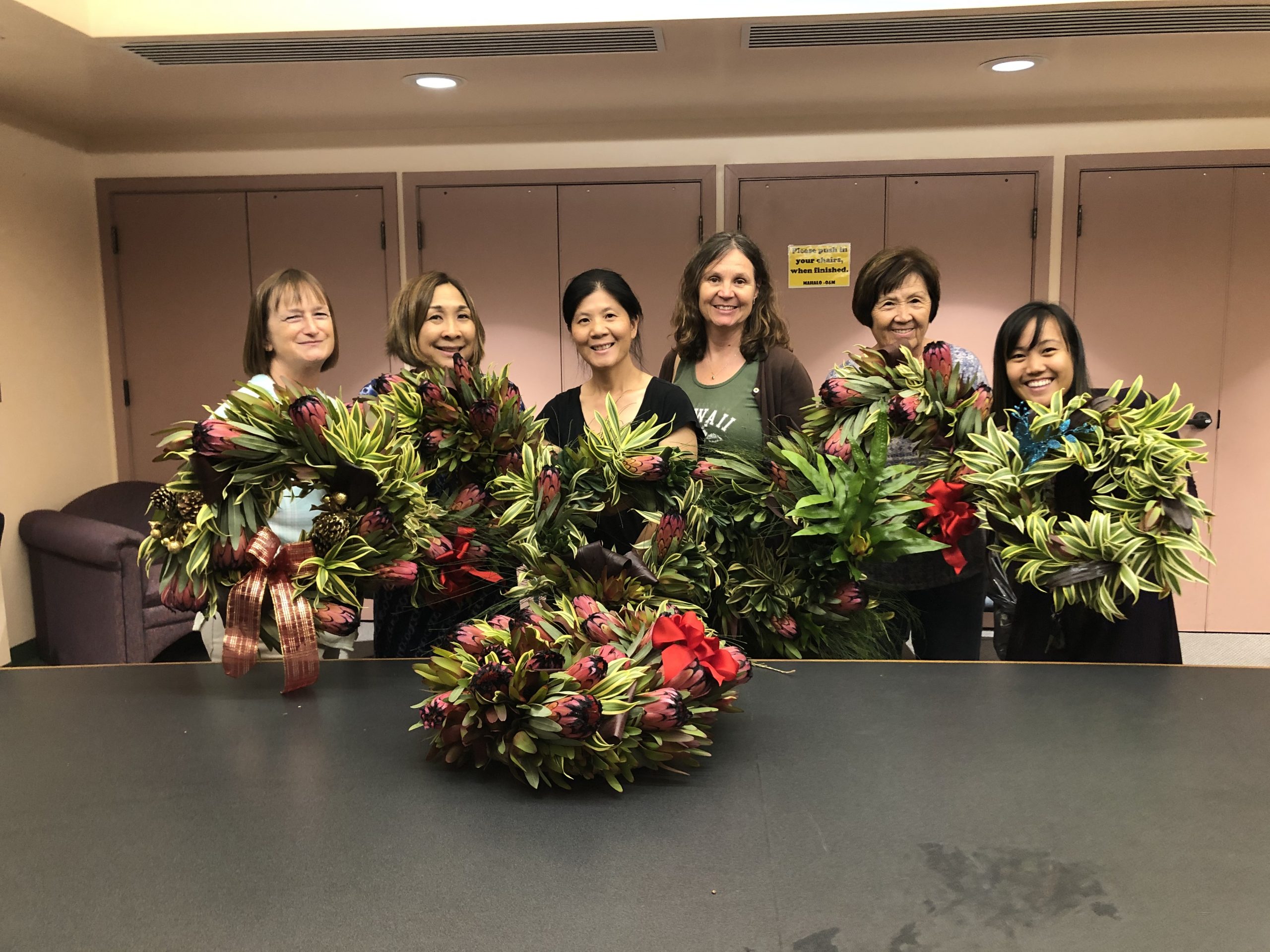UHMC employees hold up their beautiful holiday wreaths that they made