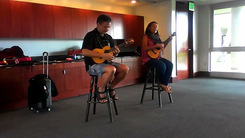 Raiatea Helm and Bryan Tolentino performing “Kalama‘ula" for IHM students at the Maui Arts and Cultural Center.